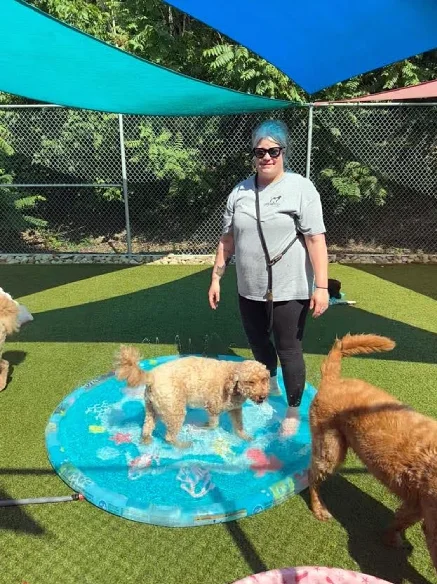 Care team Member enjoying the dogs during a waterpark activity